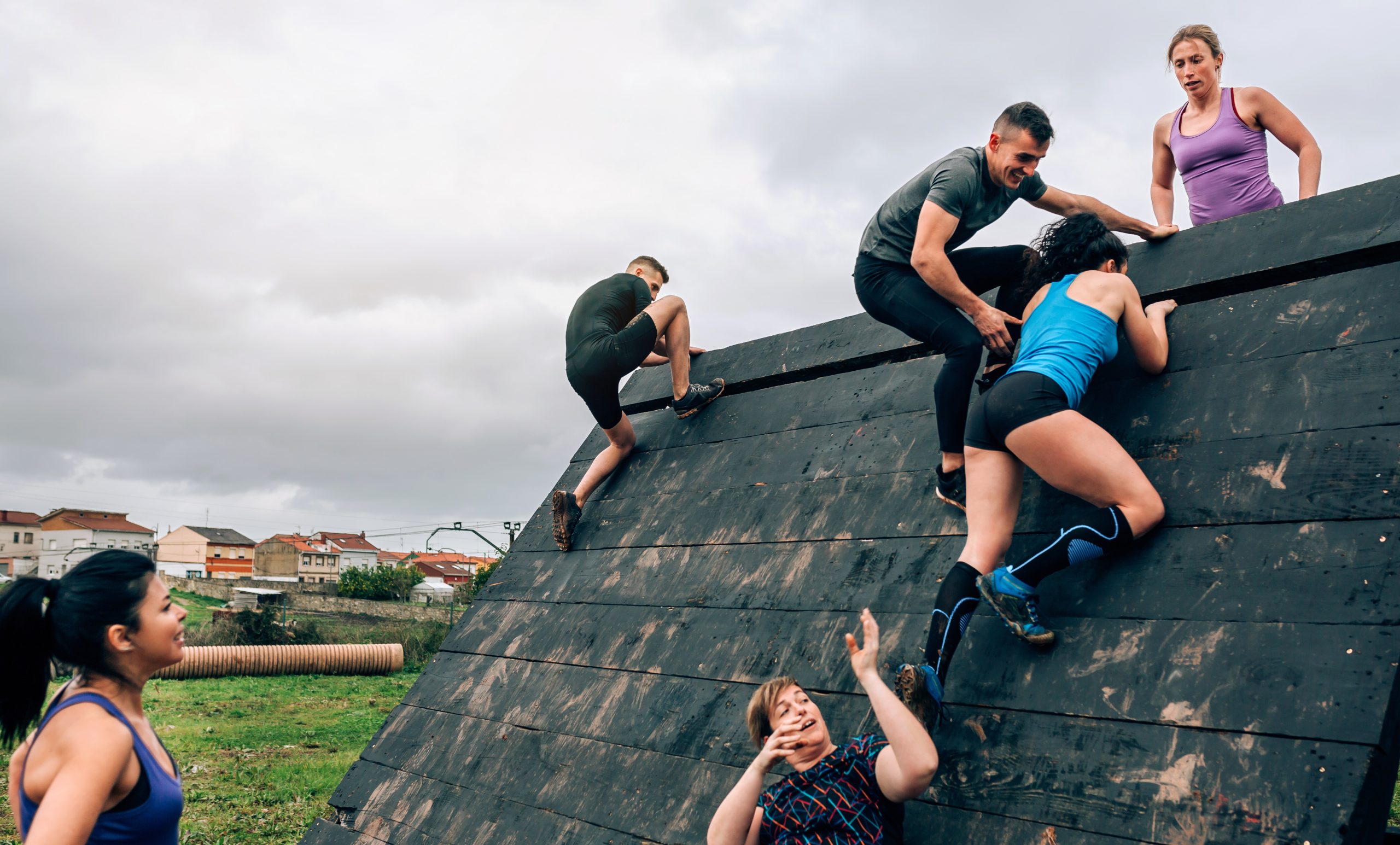 Participants in obstacle course climbing pyramid obstacle denver